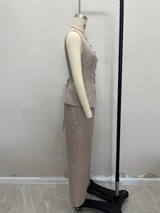 Detail view of khaki two-piece set featuring sleeveless buttoned vest and wide-leg trousers