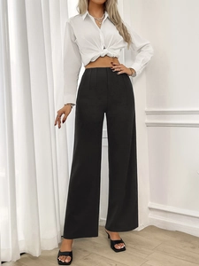 Detailed view of high-waisted black wide-leg trousers with pleated waist design