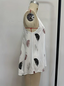 Side view of white V-neck vest featuring feather silhouette print and sleeveless design