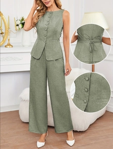 Detail view of sage green linen vest with back lacing and buttoned wide-leg pants