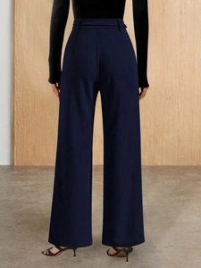 Rear view of high waisted navy blue wide leg trousers with premium drape and tailored fit