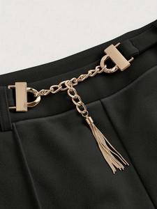 High-waist black straight trousers featuring a gold metal chain with tassel detail
