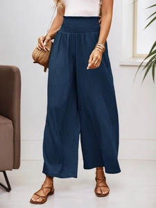 High-waisted wide-leg trousers in navy blue with pleated texture and elastic waist