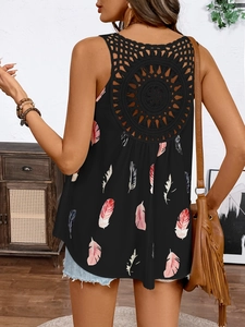 Detail of bohemian black tank top showing intricate crochet hollow out back and feather print