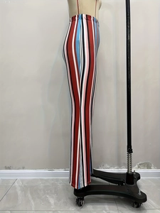 Detail view of colorful vertical stripes on high-waisted hippie style flare pants