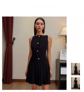 Detail of elegant black sleeveless dress with gold buttons and pleated hem details