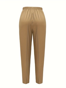Detail of khaki high waist trousers with elastic waistband and center pleat design