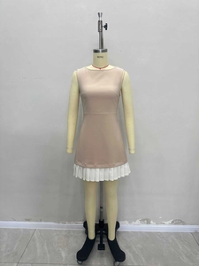 Elegant sleeveless pleated mini dress featuring a beige bodice and white hem detail