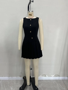 Sleeveless black mini dress with pleated hem, cinched waist, and gold decorative buttons