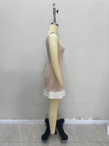 Side view of a sleeveless pink dress featuring white pleated hem on a mannequin