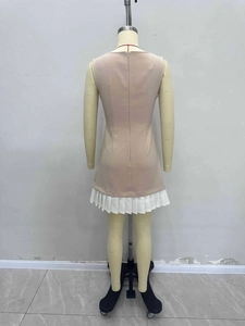 Elegant sleeveless bodycon dress in beige and white with pleated hem and back zipper