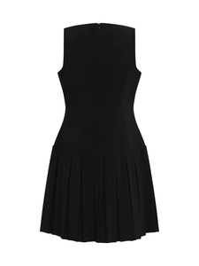 Detail of the hidden back zipper and pleated waist on a black sleeveless dress