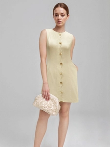 Elegantes ärmelloses Minikleid mit Seesternknöpfen und passender Clutch auf grauem Grund