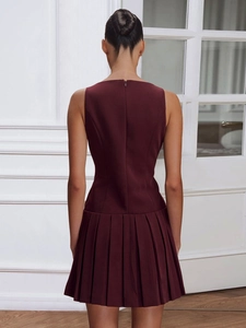 Deep burgundy sleeveless mini dress featuring a pleated skirt and hidden back zipper