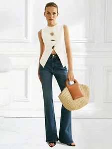 Chic white sleeveless vest with designer gold buttons and high-waist flared denim jeans