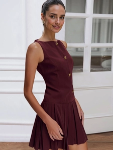 Detailed view of dark wine red sleeveless dress with decorative gold flower buttons