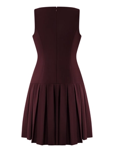 Detail view of burgundy sleeveless dress featuring pleated skirt and back zipper closure