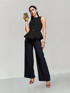 Detail of elegant black peplum top with waist tie and metallic gold belt buckle