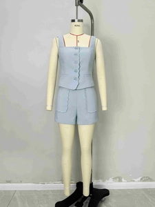Women's light blue knit set featuring a sleeveless button-down top and high waist shorts