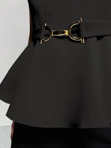 Detail of black waist belt with gold horseshoe buckle and elegant peplum hemline