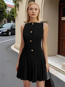 Minimalist black sleeveless pleated mini dress with elegant gold buttons for women