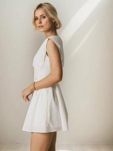 Elegant white sleeveless French style mini dress with high waist and flared skirt