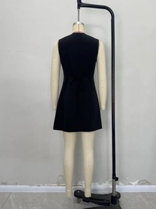 Sleeveless black A-line mini dress with asymmetrical waist tie and round neck detail