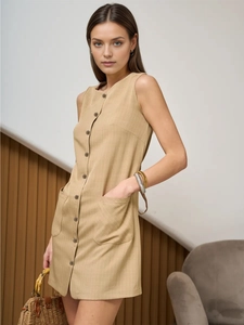 Detail of khaki sleeveless dress with vertical stripes, button-up front and large pockets