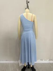 Detail of light blue one-shoulder dress showing textured bubble crepe fabric and waist pleats