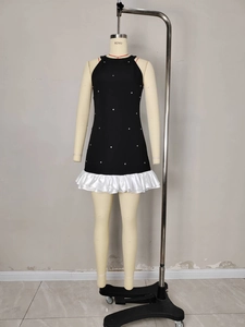 Sleeveless black halter dress with sparkling rhinestones and white tiered ruffle hem detail