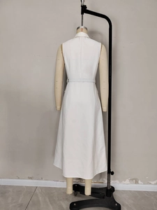 White sleeveless dress with lapel collar and belted waist, back view on mannequin