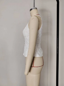 Detailed side view of a white lace sleeveless top with decorative buttons on female mannequin
