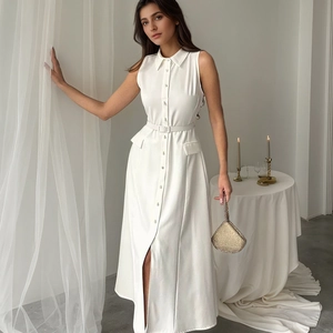 Detail of white sleeveless shirtdress featuring pointed collar and waist belt detail