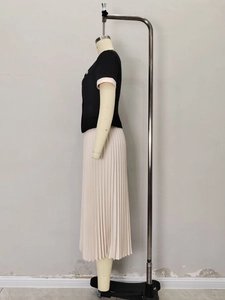 Elegant two-piece set featuring black short-sleeved cardigan and pleated long skirt