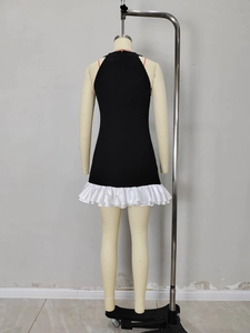 Black and white backless halter A-line dress with tiered ruffle hem on a mannequin