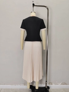 French style two-piece set featuring black short-sleeved top and beige pleated maxi skirt