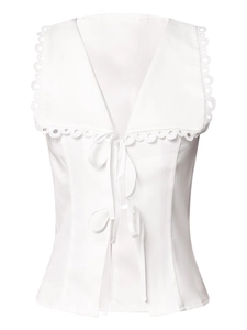 Detail of white lace collar with hollow circular patterns and delicate ribbon tie closure
