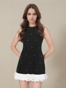 Sleeveless black halter dress with starry pearl accents and white pleated ruffle hemline