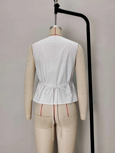 White textured sleeveless blouse with back drawstring tie on a fashion mannequin