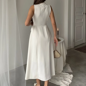 Detail of white sleeveless midi dress featuring a slim waist belt and elegant back cut
