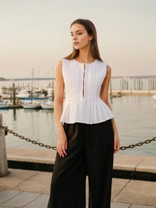 Elegant white pleated sleeveless top and black wide-leg trousers set for summer fashion
