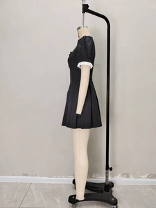 Side view of vintage black mini dress featuring a square neck and bow detail