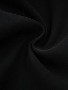 Detailed close-up showing high-quality black fabric texture with fine weaving and elegant drape