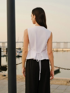 Elegant white sleeveless textured top with back straps and black high-waist wide-leg pants