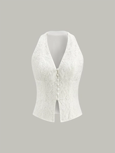 Detail view of the elegant floral lace pattern and fabric texture on a V-neck white vest