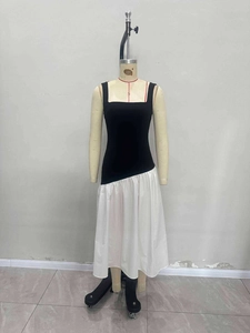 Elegant sleeveless black and white contrast midi dress with asymmetrical waistline
