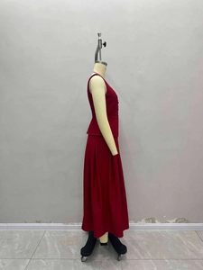 Detail of red sleeveless V-neck vest and pleated maxi skirt set for professional women
