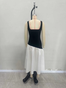 Elegant sleeveless black and white contrast dress with a square neck and flared hem