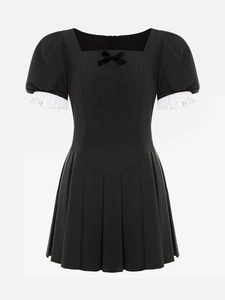 Detail of square neckline with bow and pleated puff sleeves on the black mini dress