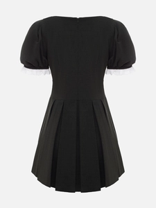 Detail of French style mini dress featuring an invisible back zipper and white lace trim